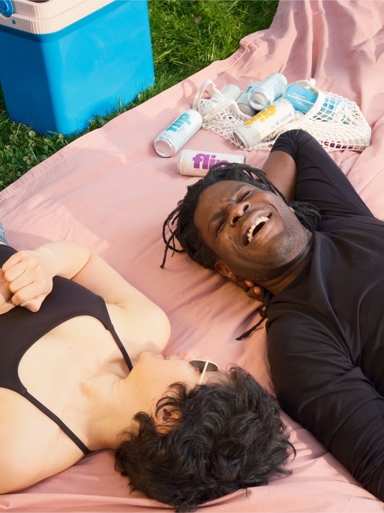 Couple drinking Flip on grass